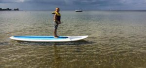 little kid on a paddle board