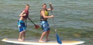 boys having fun on a paddle board