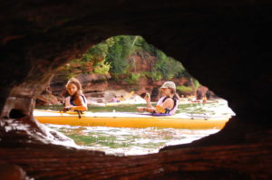 looking thru a cave at 2 kayakers
