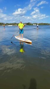 man stand up paddle boarding