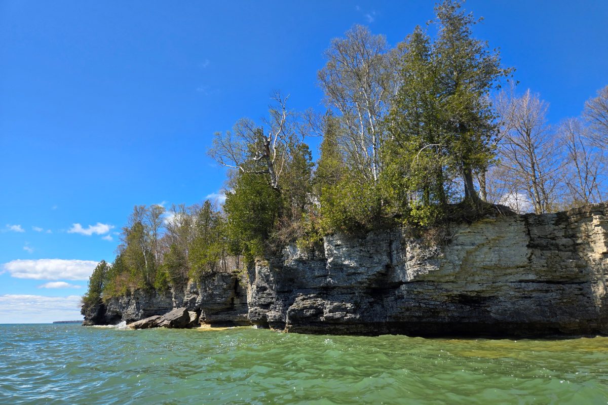 Shoreline view of Cave Point cliffside from a kayak