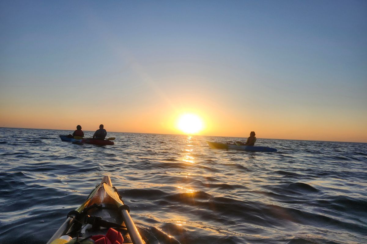 Tour group kayaking at sunset at Egg Harbor Beach in Door County, Wisconsin